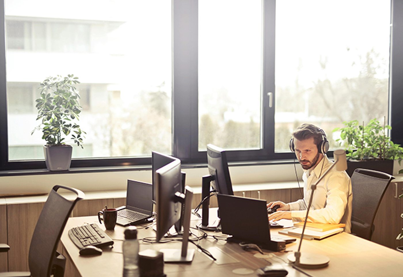 A developer working at a desk with multiple monitors