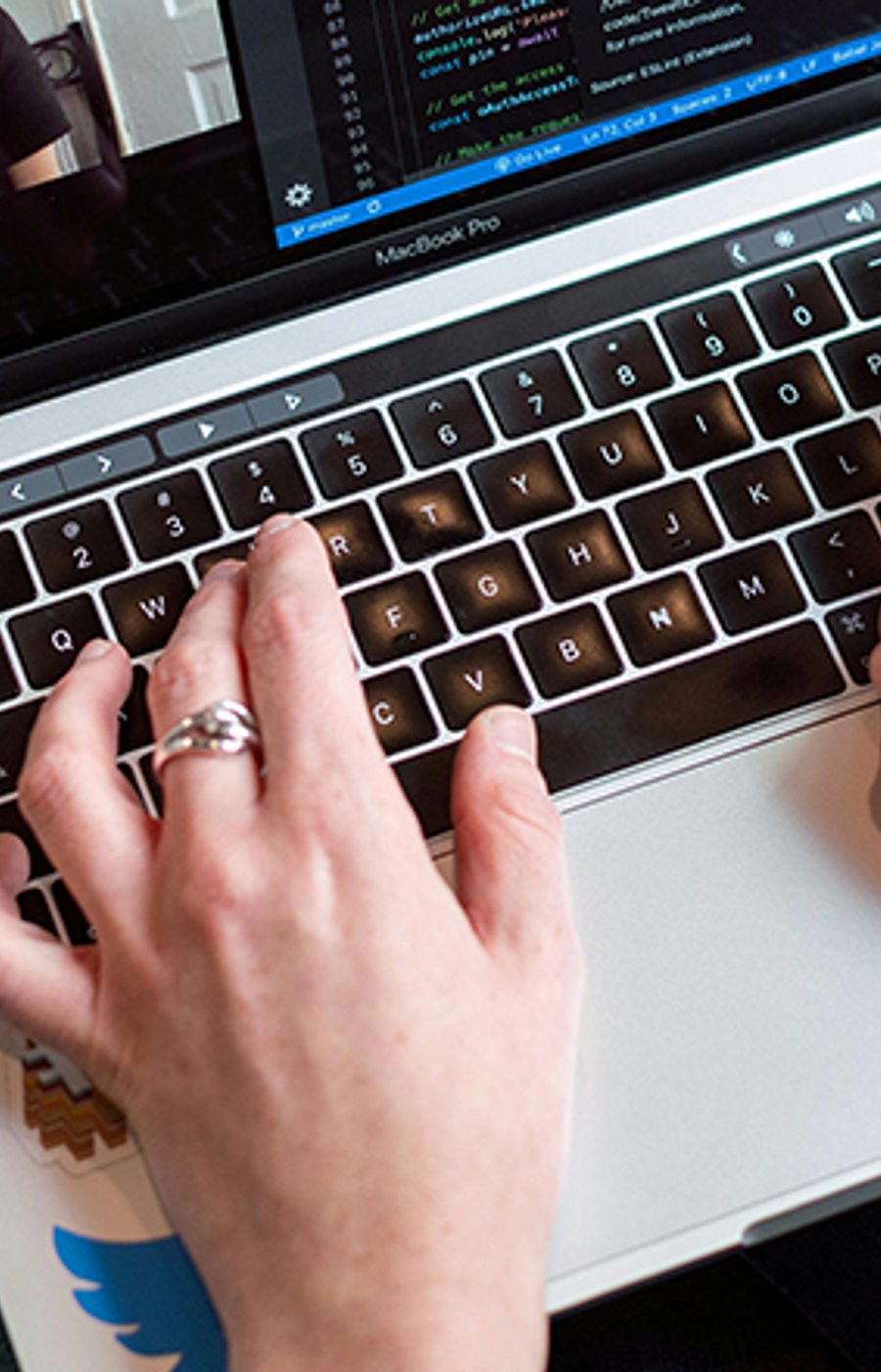 Hands on a laptop keyboard during a video call